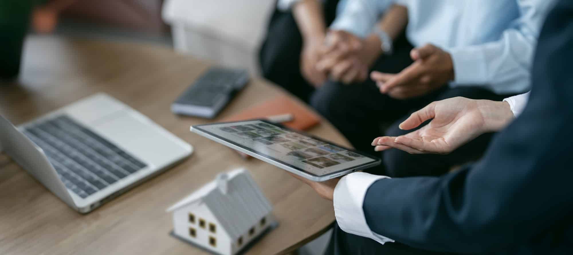 Cropped shot of Real Estate agent offers home ownership and life insurance to young couple.